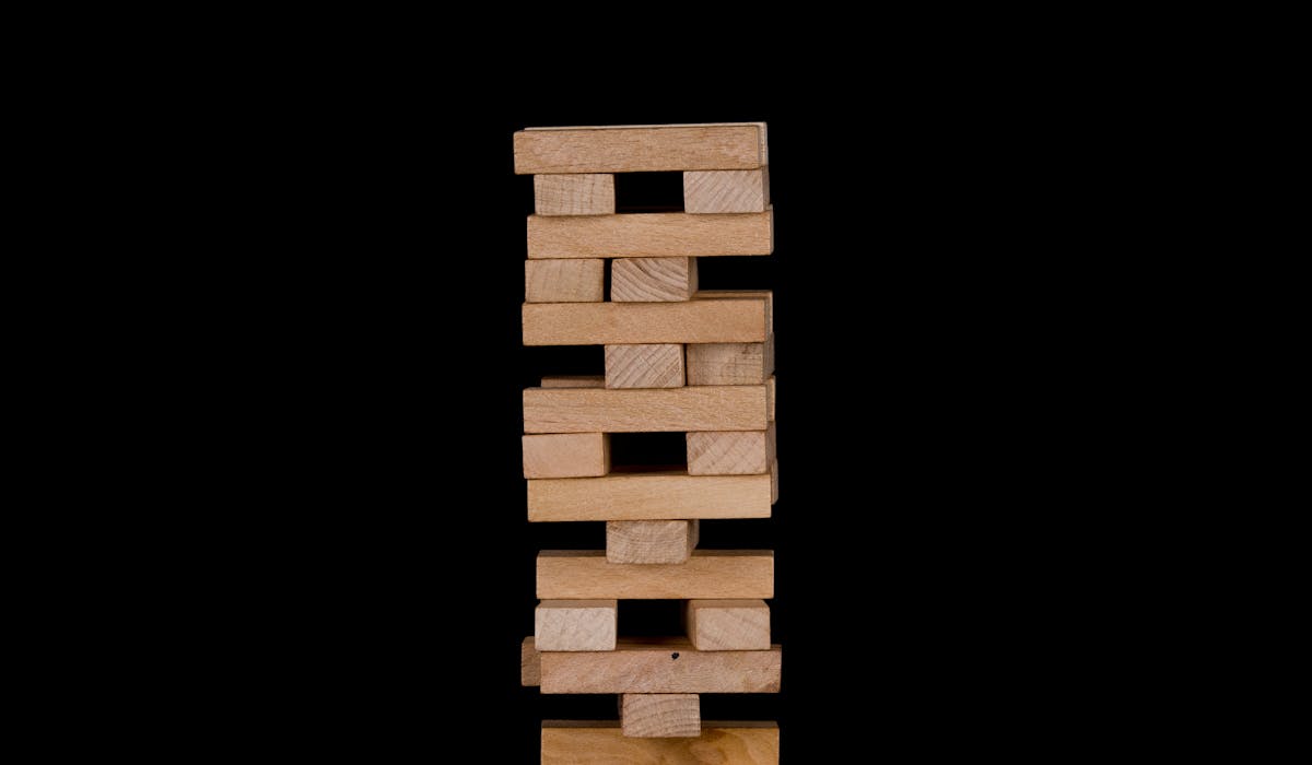Wooden stacking blocks against a dark backdrop.
