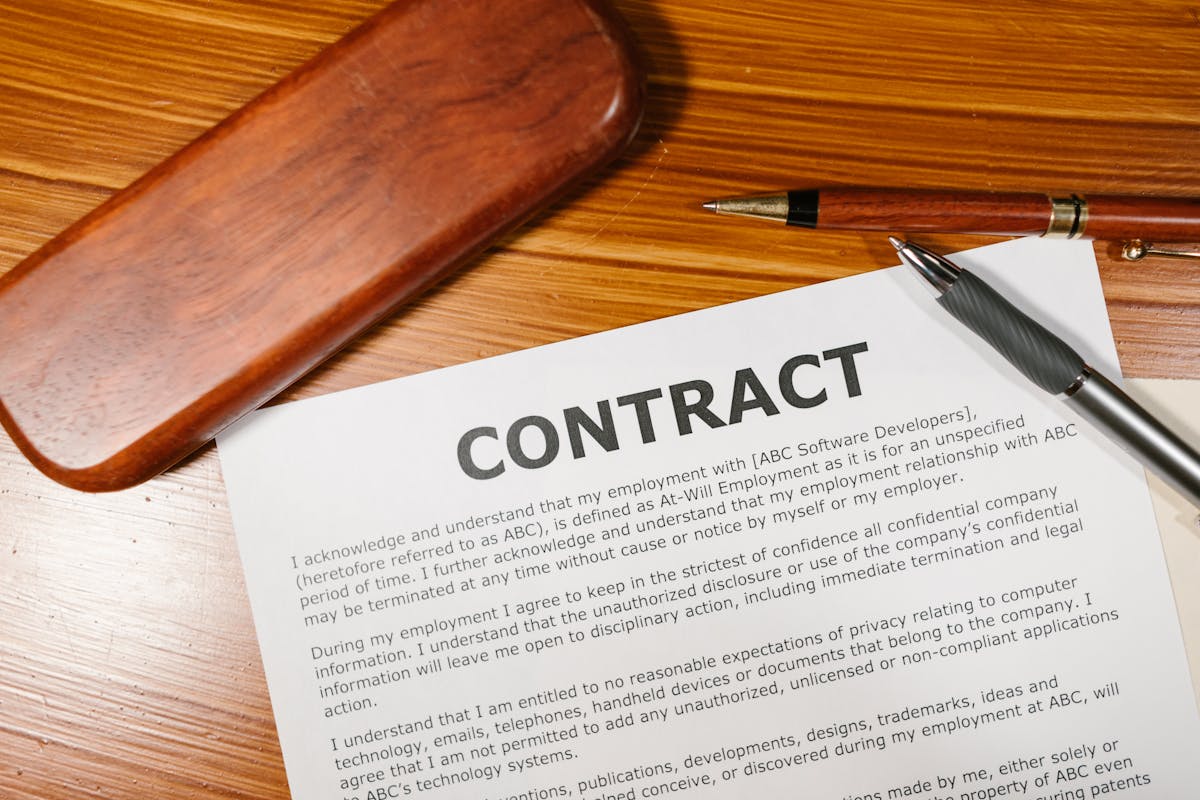 A printed statute on a wooden desk with a pen across the page.