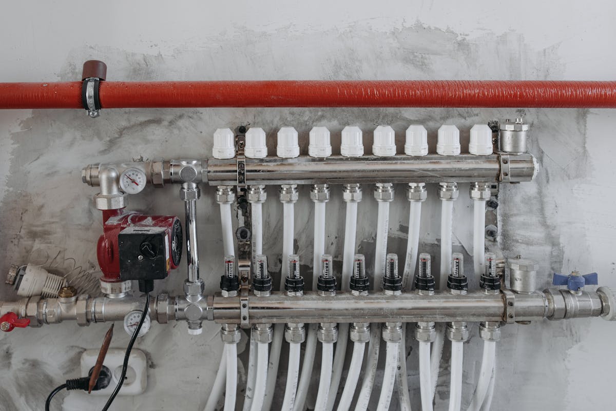 An industrial manifold with pressure gauges and connected steel pipes.
